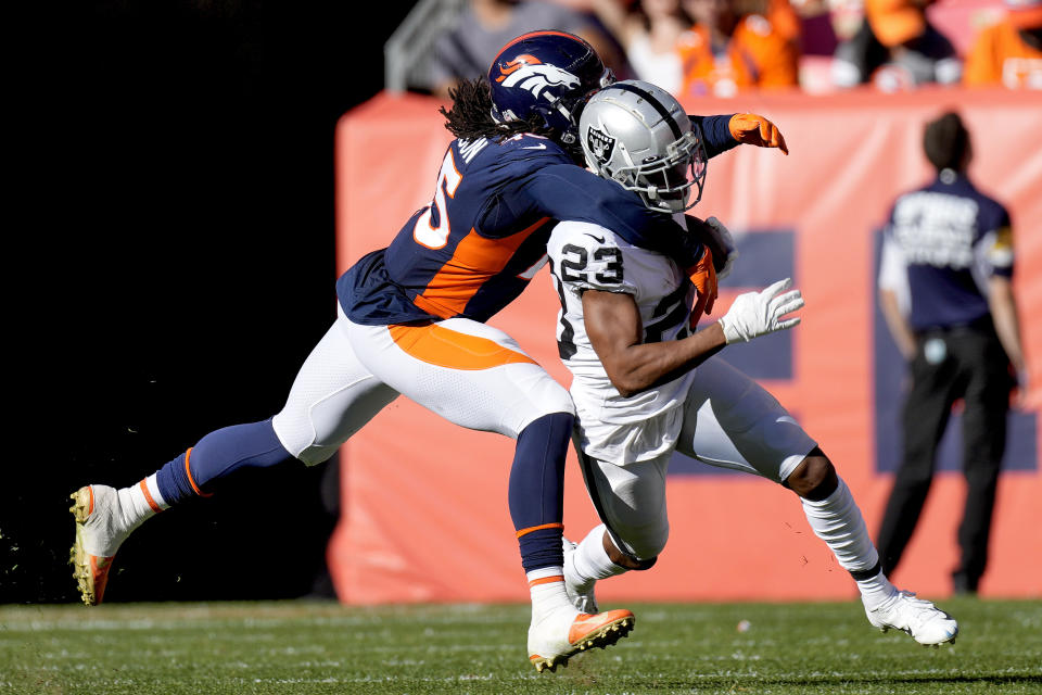 Denver Broncos inside linebacker A.J. Johnson tackles Las Vegas Raiders running back Kenyan Drake (23) during the first half of an NFL football game, Sunday, Oct. 17, 2021, in Denver. (AP Photo/David Zalubowski)