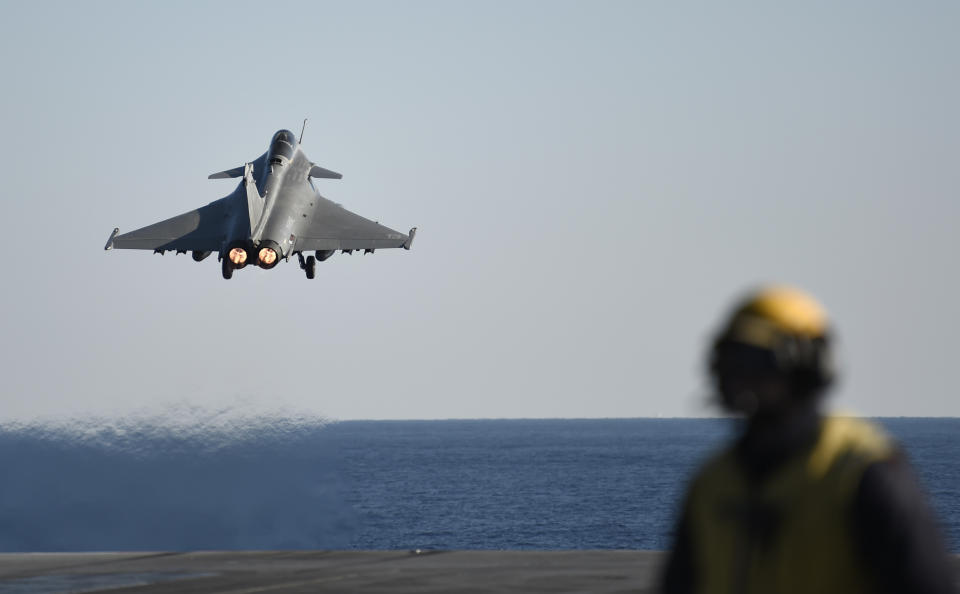 FILE - A French Rafale jet fighter takes off from France's aircraft carrier Charles-de-Gaulle, used in the U.S.-led operation against Islamic State group in Syria and Iraq in the eastern Mediterranean Sea, Friday Dec. 9, 2016. France announced the signing Friday Dec.3, 2021 of a 16 billion-euro ($18 billion) armaments mega-contract for the sale of 80 of its Rafale warplanes to the United Arab Emirates. (Stephane de Sakutin, Pool Photo via AP, File)