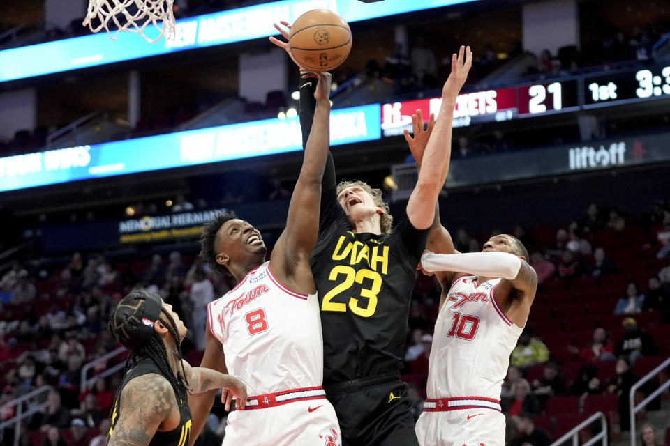 Houston Rockets forward Jae'Sean Tate (8), Utah Jazz forward Lauri Markkanen (23), and Rockets forward Jabari Smith Jr. (10) reach for a rebound during the first half of an NBA basketball game Saturday, Jan. 20, 2024, in Houston. (AP Photo/Eric Christian Smith)