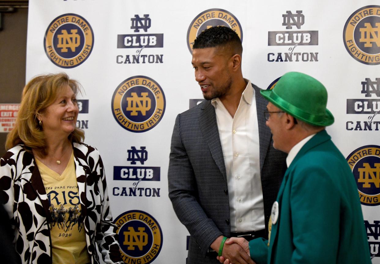 Marion and Michael DePasquale of Canton meet University of Notre Dame Head Football Coach Marcus Freeman during his visit to the Notre Dame Club of Canton event at Massillon Eagles Post 190 Tuesday, May 07, 2024.