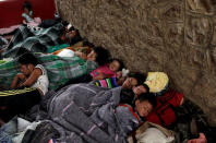 Children, part of a caravan of Central American migrants moving through Mexico toward the U.S. border, sleep at a sports centre in Matias Romero, Mexico April 5, 2018. REUTERS/Henry Romero