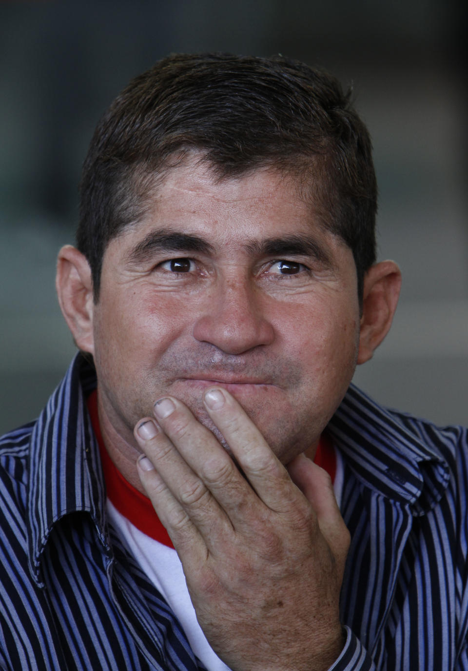 Sea survivor Jose Salvador Alvarenga pauses during an interview, after arriving at the airport in Mexico City, Friday, March 14, 2014. The Salvadoran fisherman, who was lost at sea for 13 months, traveled from El Salvador to Mexico to fulfill a promise he made to his dead sea mate, Mexican Ezequiel Cordoba. Alvarenga said Cordoba died a month into their ordeal because he couldn't stomach the diet of raw fish, turtles and birds. (AP Photo/Marco Ugarte)