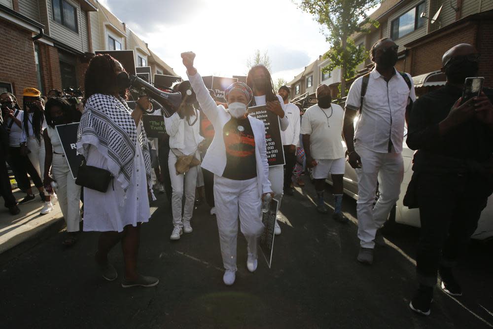 MOVE member Pam Africa leads a group along the 6200 block of Osage Avenue in Philadelphia, Thursday, May 13, 2021, on the 36th anniversary of the MOVE bombing and the city’s first official day of remembrance for MOVE. (Yong Kim/The Philadelphia Inquirer via AP)