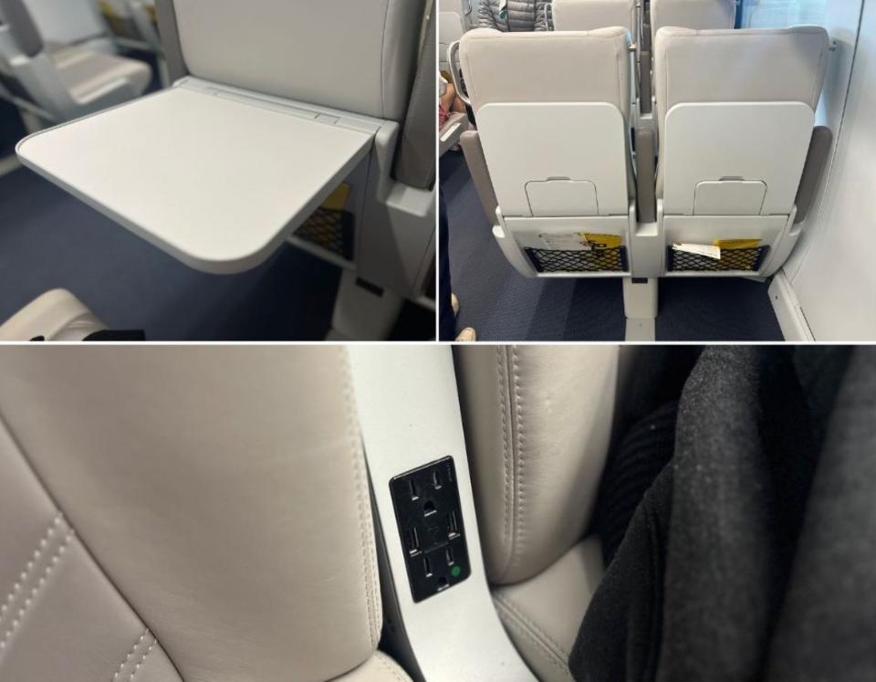 The tray table folded down, seatbacks, and a picture of the power outlet.