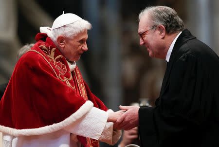 FILE PHOTO: Pope Benedict XVI (L) is greeted by Matthew Festing, Grand Master of the Sovereign Order of Malta, during a mass, conducted by Cardinal Tarcisio Bertone, for the 900th anniversary of the Order of the Knights of Malta at the St. Peter Basilica at the Vatican February 9, 2013. REUTERS/Alessandro Bianchi/File Photo