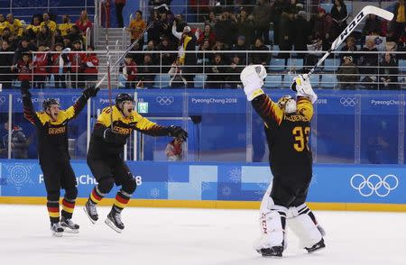 Ice Hockey - Pyeongchang 2018 Winter Olympics - Men's Quarterfinal Match - Sweden v Germany - Kwandong Hockey Centre, Gangneung, South Korea - February 21, 2018 - Christian Ehrhoff and goalie Danny aus den Birken of Germany celebrates after the match. REUTERS/Grigory Dukor