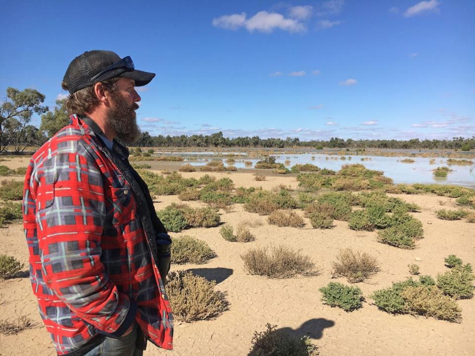 <span class="caption">Bush Heritage Reserve Manager Greg Carroll at Naree Station Reserve, Budjiti Country, NSW after a major rainfall event.</span> <span class="attribution"><span class="source">Rebecca Spindler</span></span>