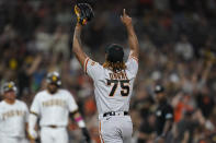 San Francisco Giants relief pitcher Camilo Doval (75) reacts after San Diego Padres' Tommy Pham grounded into a double play with the bases loaded to end the fifth inning of a baseball game Wednesday, Sept. 22, 2021, in San Diego. (AP Photo/Gregory Bull)