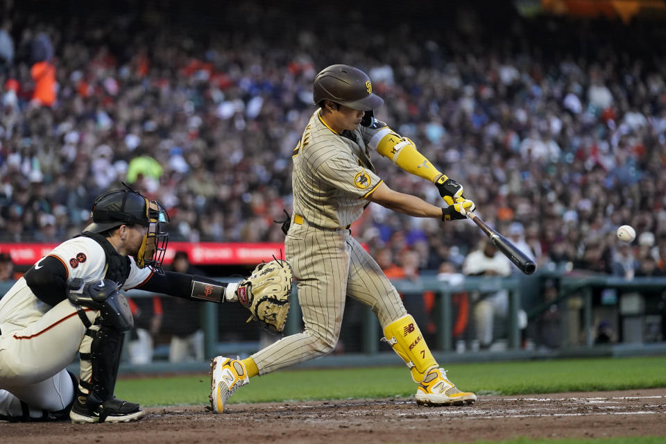 San Diego Padres' Ha-Seong Kim, right, hits a two-run single in front of San Francisco Giants catcher Patrick Bailey during the fourth inning of a baseball game in San Francisco, Monday, June 19, 2023. (AP Photo/Jeff Chiu)
