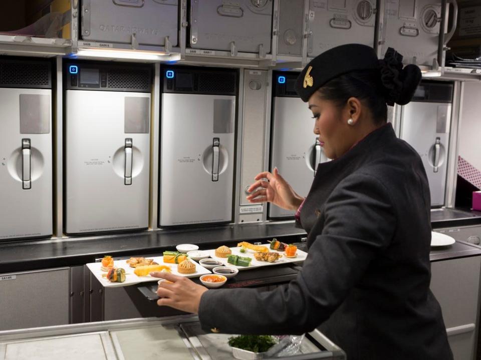 A flight attendant prepping business meals on an A350 in 2018.