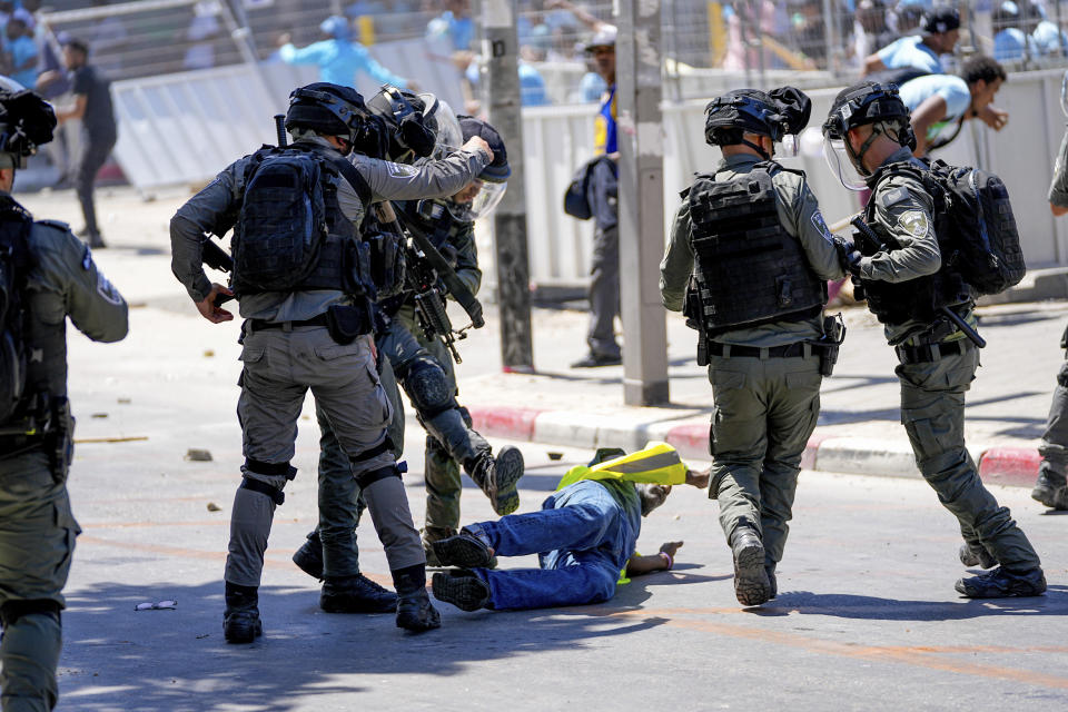 Eritrean protesters clash with Israeli riot police in Tel Aviv, Israel, Saturday, Sept. 2, 2023. Hundreds of Eritrean asylum seekers smashed shop windows and police cars in Tel Aviv on Saturday, clashing with police during a protest against an event to 30 years of independence, organized by the government of Eritrea. The Israeli police said more than 20 people were injured in the clashes, including a dozen police officers. (AP Photo/Ohad Zwigenberg)