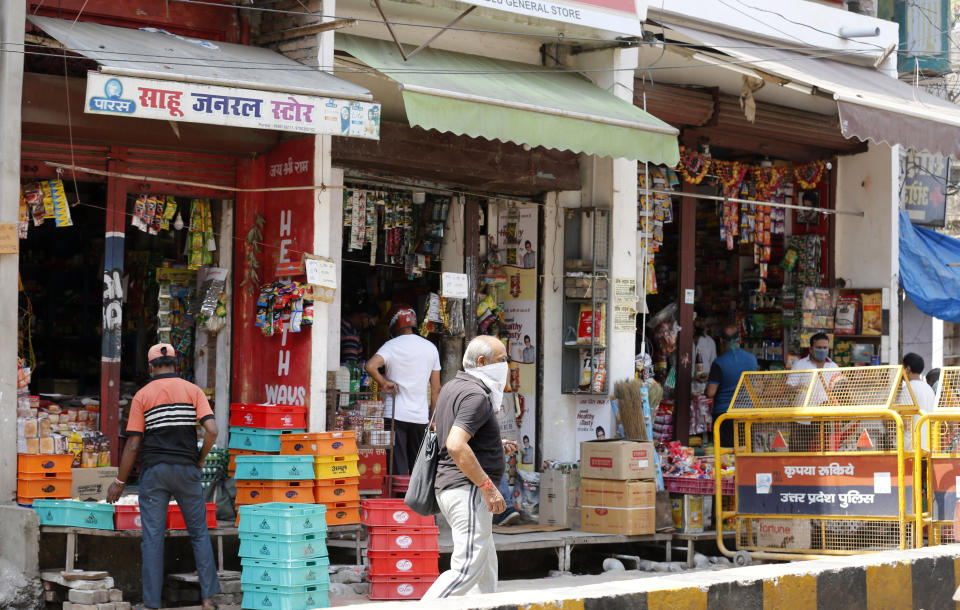 Grocery shops are seen open during lockdown to prevent the spread of new coronavirus in Prayagraj, India, Saturday, April 25, 2020. A tentative easing around the world of coronavirus lockdowns gathered pace Saturday with the reopening in India of neighborhood stores that many of the country’s 1.3 billion people rely on for everything from cold drinks to mobile phone data cards. (AP Photo/Rajesh Kumar Singh)