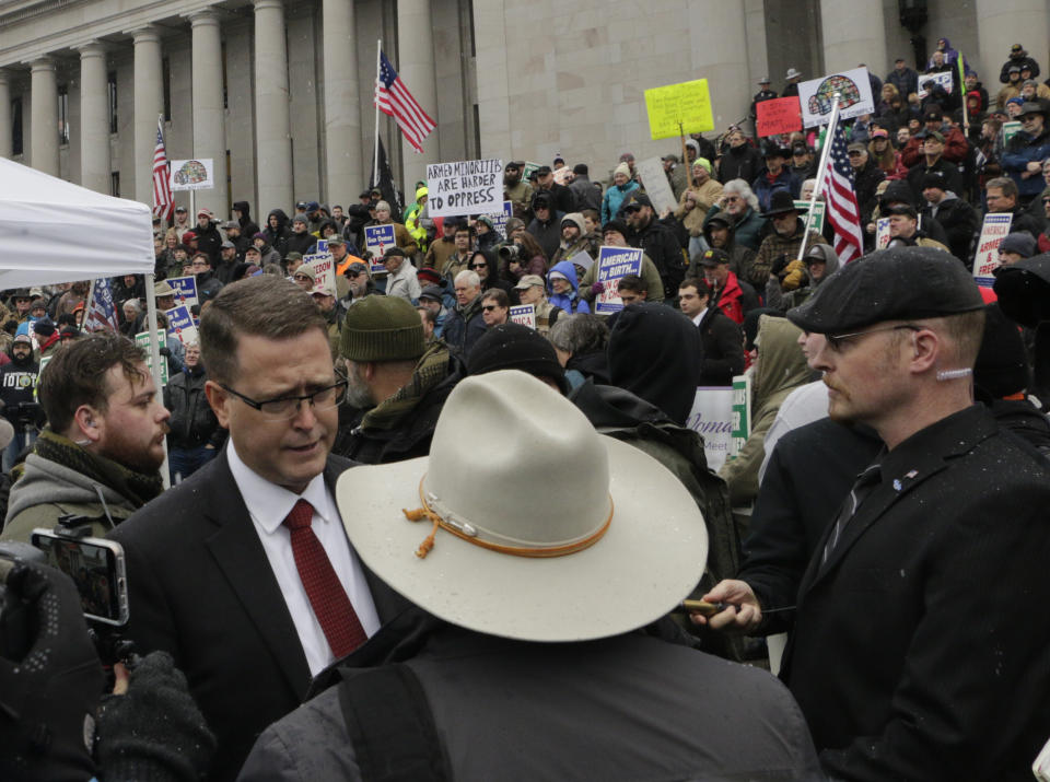 Republican Rep. Matt Shea meets with supporters after speaking at a gun-rights rally in Olympia, Wash., Friday, Jan. 17, 2020. Shea was suspended from the Republican caucus in the wake of a December report that found he was involved in anti-government activities and several lawmakers have called on him to resign. Shea, who says he's been targeted for his work against anti-gun bills, says he will not resign and will run for re-election this year. (AP Photo/Rachel La Corte)