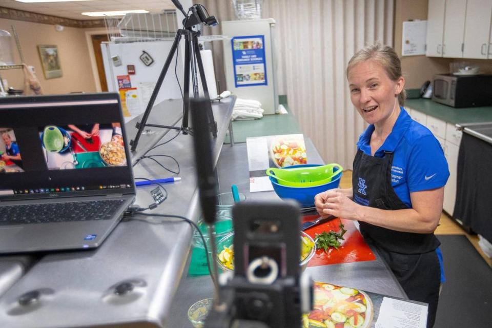 Woodford County Family & Consumer Sciences Extension Agent Elizabeth Coots uses two smartphones to livestream her preeraption of a recipe Wednesday, July 7, 2021 at the Woodford Co. Extension Office in Versailles.