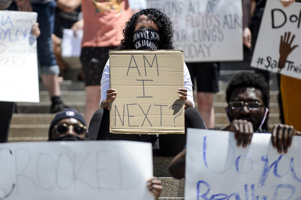 DENVER, CO - MAY 29: Makeda Gebre holds a sign asking, "am I next," as people gather to protest the death of George Floyd on the steps of the Colorado state capitol on May 29, 2020 in Denver, Colorado. Yesterday, protests in Denver were broken up with tear gas and pepper spray after someone fired gunshots near the capitol. (Photo by Michael Ciaglo/Getty Images)