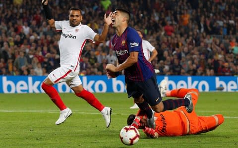 Luis Suarez is brought down by Sevilla keeper Tomas Vaclik - Credit: reuters