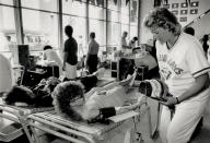 July 18,1989: Donating in the dome. Kathy Henke, wife of Blue Jay hurler Tom Henke, puts in some relief work of her own, handing out souvenir hats to donors at the SkyDome blood clinic. (Photo by Ron Bull/Toronto Star via Getty Images)