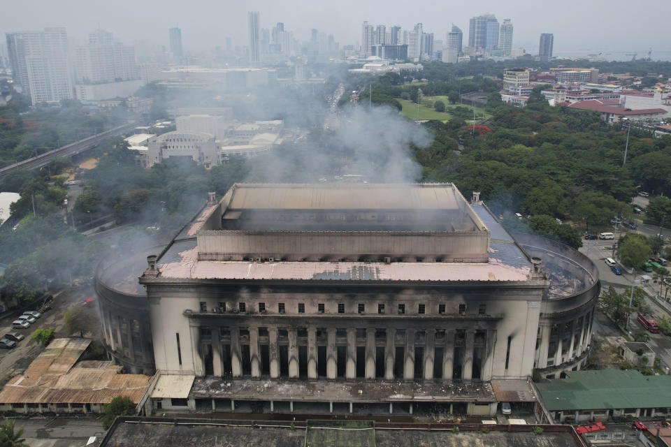 Smoke billows from the still smoldering Manila Central Post Office as a fire hits early Monday, May 22, 2023 in Manila, Philippines. A massive fire tore through Manila's historic post office building overnight, police and postal officials said Monday. (AP Photo/Aaron Favila)