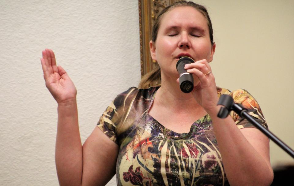 Brook Hollow Christian Church co-pastor Penny Biddy leads the singing at the April 3 service. She serves the congregation with Chesna Riley.