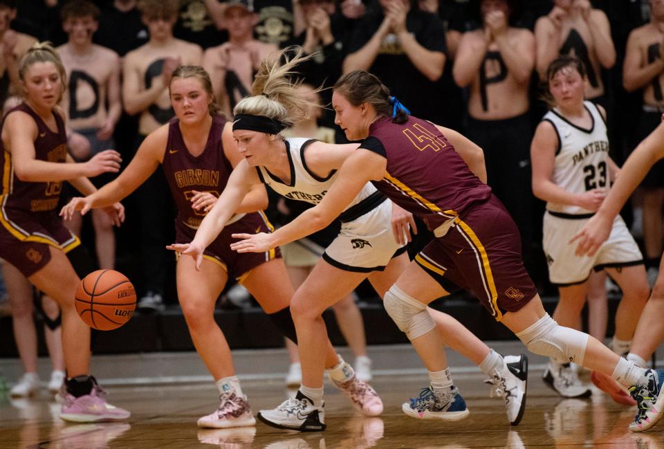 Corydon Central's Ava Weber (13) is pressured by Gibson Southern's Chloey Graham (41) during their Class 3A South Semi-State game at Jasper High School Saturday morning, Feb. 18, 2023.
