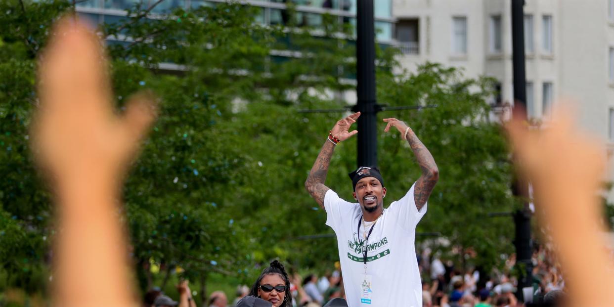 Brandon Jennings, the former Bucks player who came up with the "Bucks in six" slogan hypes the crowd during the Bucks celebration parade on Thursday, July 22, 2021, in Milwaukee.