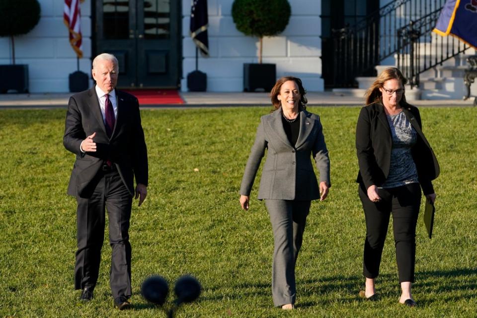 President Joe Biden, with Vice President Kamala Harris and Heather Kurtenbach, with Iron Workers Local 86 in Seattle, arrives to speak before signing the $1.2 trillion bipartisan infrastructure bill during a ceremony on the South Lawn of the White House on Monday (AP)