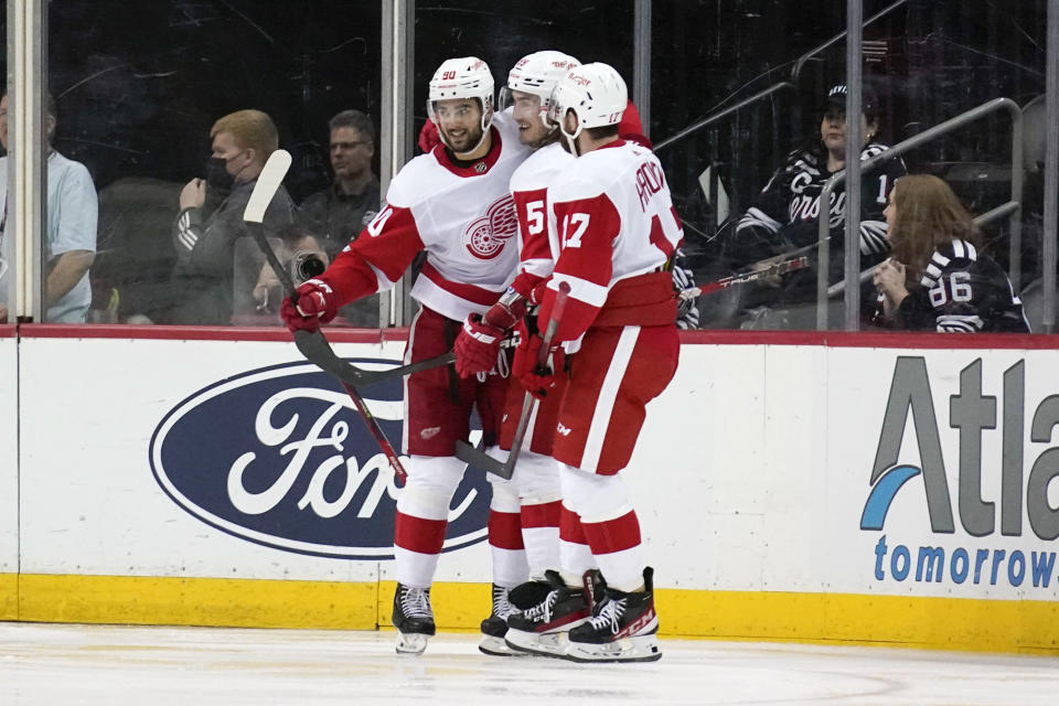Detroit Red Wings' Joe Veleno, left, celebrates his goal with teammates during the third period of an NHL hockey game against the New Jersey Devils in Newark, N.J., Friday, April 29, 2022. The Red Wings defeated the Devils 5-3. (AP Photo/Seth Wenig)