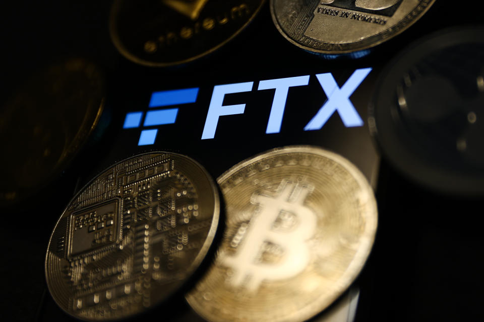 FTX logo displayed on a phone screen and representation of cryptocurrencies are seen in this illustration photo taken in Krakow, Poland on November 14, 2022. (Photo by Jakub Porzycki/NurPhoto via Getty Images)