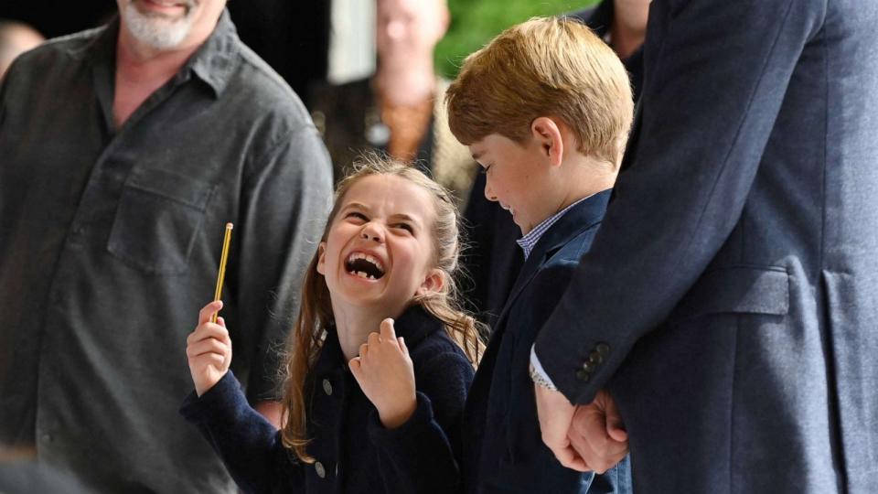 PHOTO: Princess Charlotte laughs as she conducts a band next to her brother Prince George during their visit to Cardiff Castle as part of the royal family's tour for Queen Elizabeth's Platinum Jubilee celebrations in Cardiff, Wales, Britain, June 4, 2022. (Ashley Crowden/Pool via Reuters)