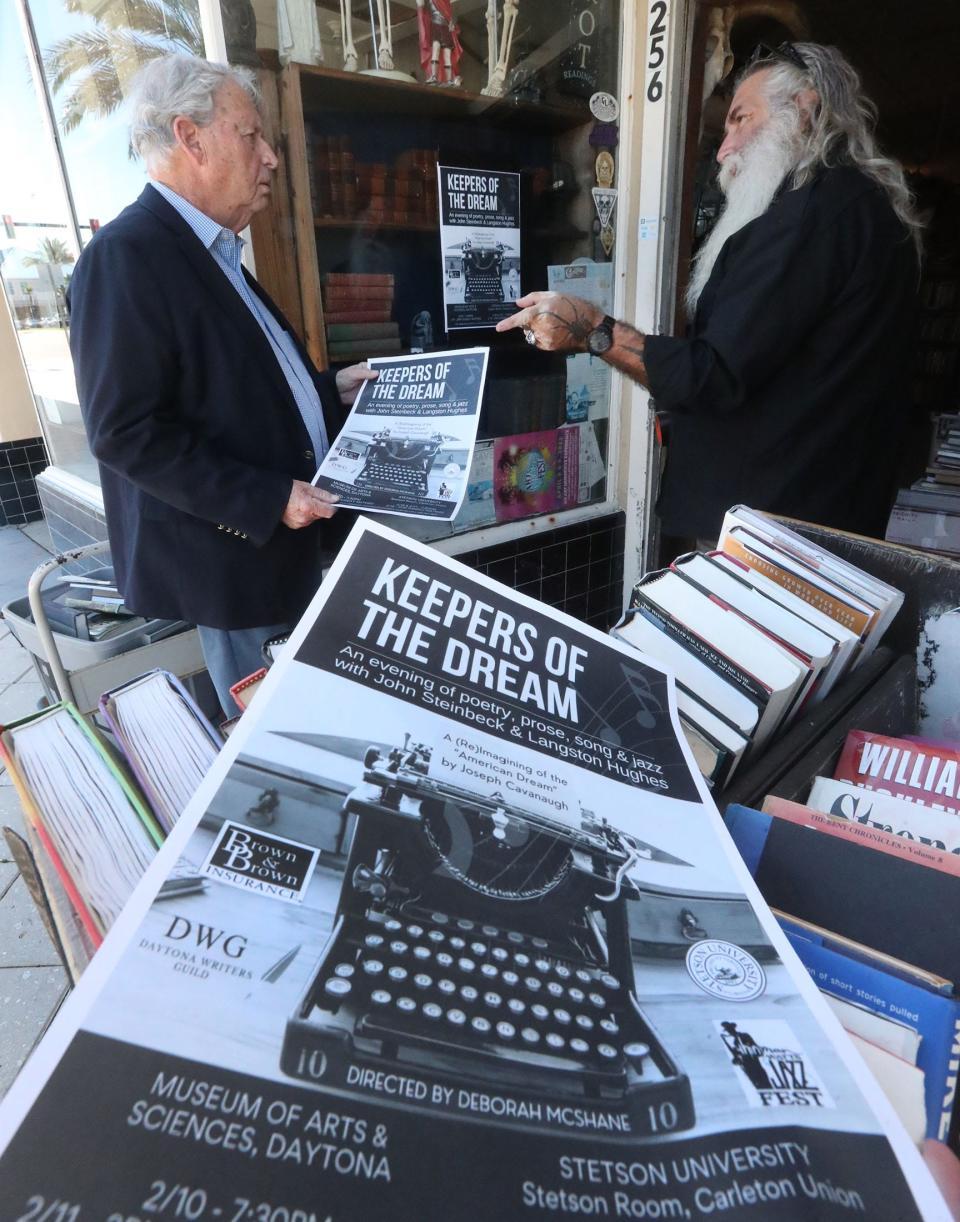 Ormond Beach poet and playwright Joe Cavanaugh talks with James Sass, owner of Abraxas Books on Beach Street, while putting up posters for "Keepers of the Dream," his play that envisions a meeting of literary titans John Steinbeck and Langston Hughes. Cavanaugh found some materials for his research on the writers at the bookstore.