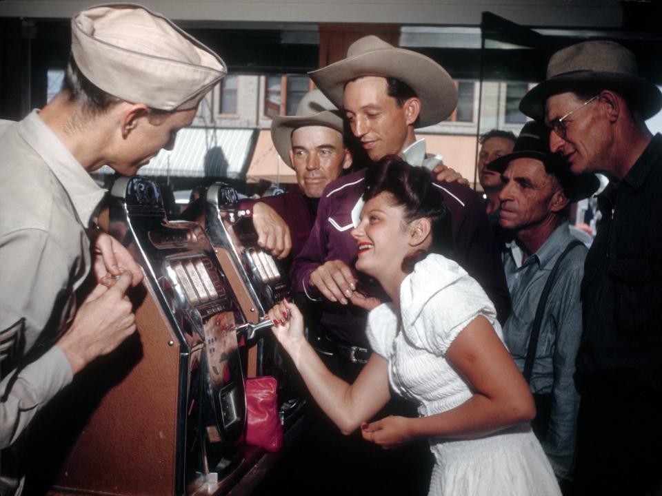 Gamblers play the slots in a Fremont street Casino in July 1942 in Las Vegas, Nevada.