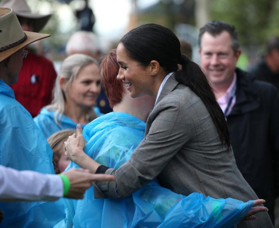 The Duchess of Sussex hugs a woman on their visit to Dubbo (PA)