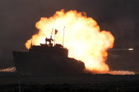 A Japanese Ground-Self Defense Force (JGDDF) Type 90 tank fires its gun at a target during the annual drill with live ammunitions exercise at Minami Eniwa Camp Monday, Dec. 6, 2021, in Eniwa, on the northern Japan island of Hokkaido. Dozens of tanks are rolling over the next two weeks on Hokkaido, a main military stronghold for a country with perhaps the world's most little known yet powerful army. (AP Photo/Eugene Hoshiko)