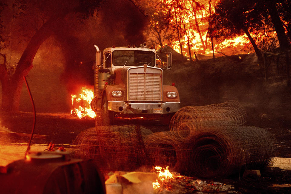 Flames from the Glass Fire burn a truck in a Calistoga, Calif., vineyard Thursday, Oct. 1, 2020. (AP Photo/Noah Berger)