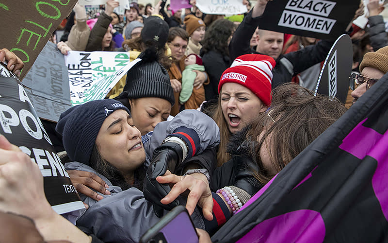 An abortion rights demonstrator and an anti-abortion demonstrator face off in front of the Supreme Court during the Women’s March, which largely focused on abortion rights, in Washington, D.C., on Jan. 22. <em>Associated Press/Amanda Andrade-Rhoades</em>