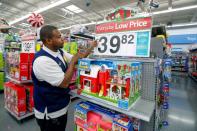 FILE PHOTO: An employee puts up a price tag ahead of Black Friday at a Walmart store in Chicago