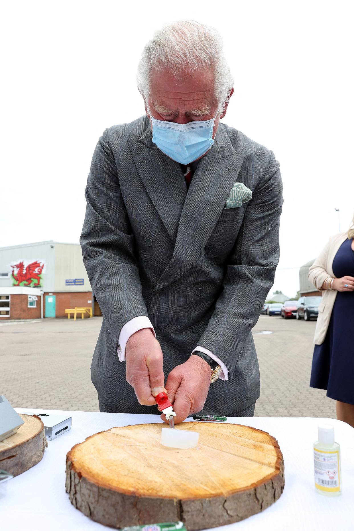 Britain's Prince Charles, Prince of Wales lights Fire Dragon fuel during a visit to BCB International, a supplier of protective, medical and defence equipment, in Cardiff on May 14, 2021, during his day-long visit to Wales. (Photo by Chris Jackson / POOL / AFP) (Photo by CHRIS JACKSON/POOL/AFP via Getty Images)