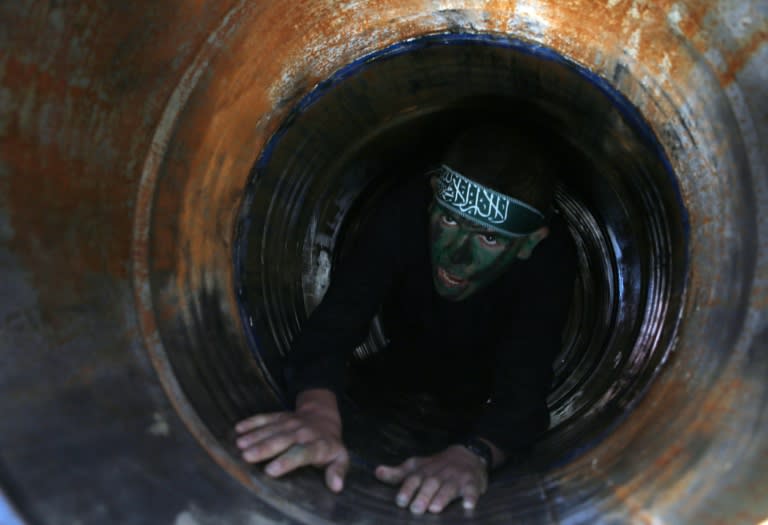 A Palestinian youth crawls in a tunnel during a graduation ceremony for a training camp run by the Hamas movement on January 29, 2015 in Khan Yunis, in the southern Gaza Strip