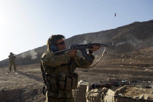 File photo of an Australian soldier firing an AK-47 assault rifle used by Afghan soldiers during practice firing at a forward operating base (FOB) in Mirwais in the southern province of Uruzgan. Australian troops will begin withdrawing as soon as Afghanistan President Hamid Karzai declared Afghans can take responsibility for Uruzgan province, where most Australian forces are based