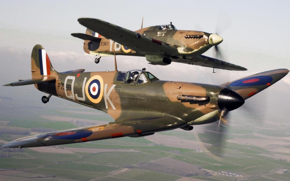 A Spitfire (front) flying alongside a Hurricane from the Battle of Britain Memorial Flight - PA