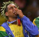 ATHENS - AUGUST 29: Sergio Dutra Santos #10 of Brazil cries as he kisses the gold medal for men's indoor Volleyball during ceremonies on August 29, 2004 during the Athens 2004 Summer Olympic Games at the Peace and Friendship Stadium part of the Faliro Coastal Zone Olympic Complex in Athens, Greece. Brazil defeated Italy to win gold. (Photo by Adam Pretty/Getty Images)