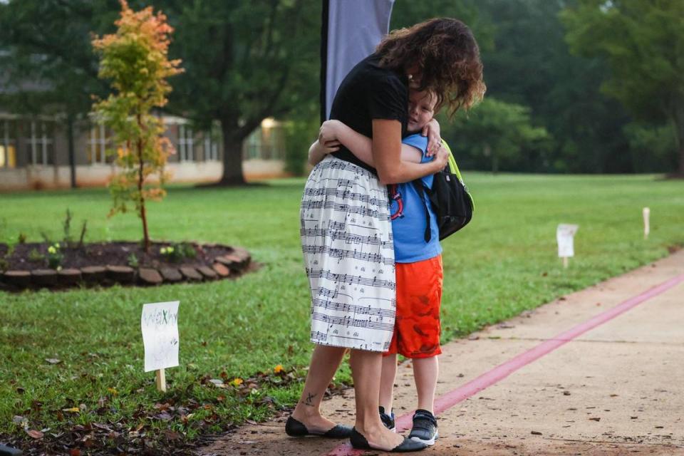 Classroom music teacher Emily Rhodes, left, hugs a student as he arrives for the frist day of school at Waxhaw Elementary School on Monday, August 28, 2023. Melissa Melvin-Rodriguez/mrodriguez@charlotteobserver.com