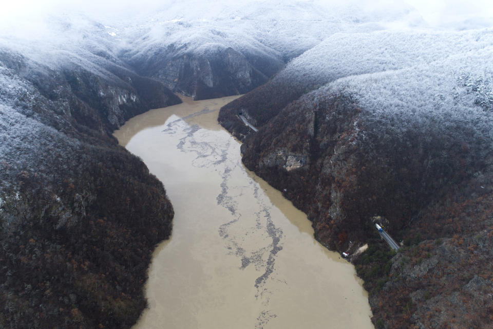 Waste floating in the Drina river near Visegrad, Bosnia, Friday, Jan. 20, 2023. Tons of waste dumped in poorly regulated riverside landfills or directly into the rivers across three Western Balkan countries end up accumulating during high water season in winter and spring, behind a trash barrier in the Drina River in eastern Bosnia. (AP Photo/Armin Durgut)