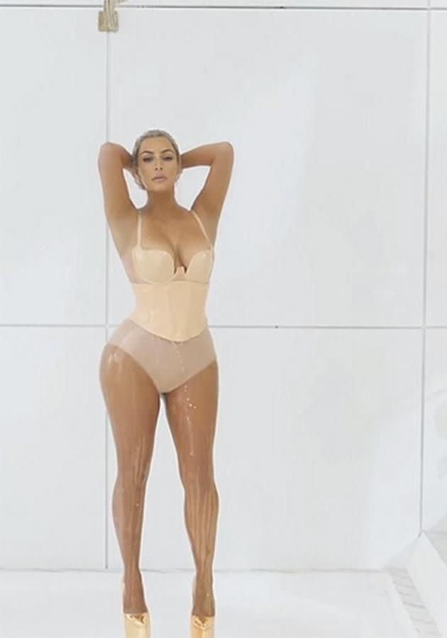 Kim showers in milk in the video.