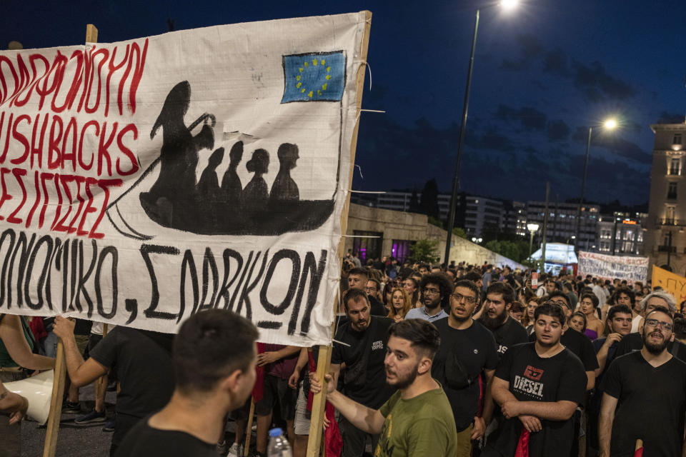 Protesters hold a banner during a demonstration following a deadly migrant shipwreck off Greece, in Athens, on Thursday, June 15, 2023. Greece declared three days of mourning after a fishing boat crammed to the gunwales with migrants trying to reach Europe capsized and sank Wednesday off the coast of Greece, authorities said, killing and missing multiple people in one of the worst disasters of its kind this year. (AP Photo/Petros Giannakouris)