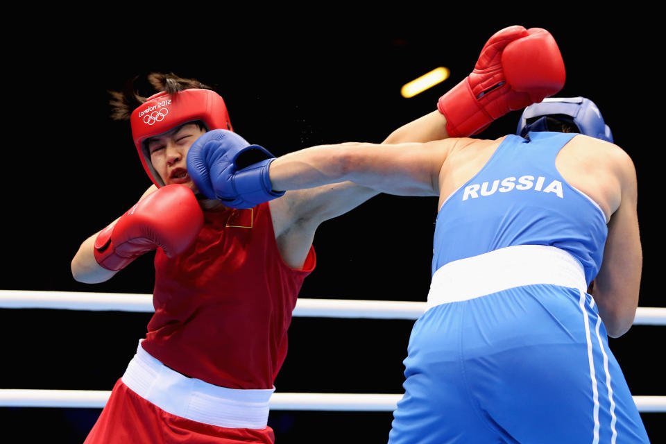 LONDON, ENGLAND - AUGUST 08: Nadezda Torlopova (R) of Russia in action against Jinzi Li of China during the Women's Middle (75kg) Boxing semifinals on Day 12 of the London 2012 Olympic Games at ExCeL on August 8, 2012 in London, England. (Photo by Scott Heavey/Getty Images)