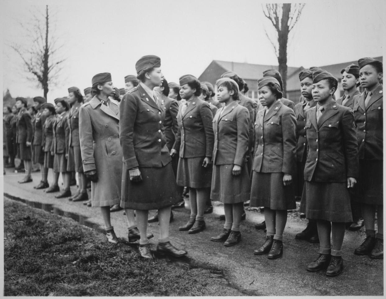 Black-and-white image of Maj. Charity Adams and Capt. Abbie N. Campbell inspecting a contingent of the Women's Army Corps.