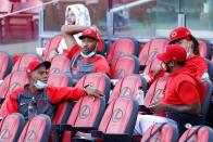 <p>Raisel Iglesias #26 and Pedro Strop #46 of the Cincinnati Reds talk among a gathering of pitchers in the stands in the second inning of an exhibition game against the Detroit Tigers at Great American Ball Park on July 22 in Cincinnati.</p>