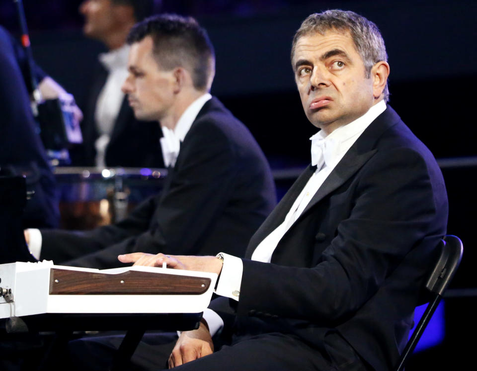 Actor Rowan Atkinson, known for his role as Mr Bean, performs during the opening ceremony of the London 2012 Olympic Games at the Olympic Stadium July 27, 2012. REUTERS/Kai Pfaffenbach (BRITAIN - Tags: SPORT OLYMPICS ENTERTAINMENT TPX IMAGES OF THE DAY) 