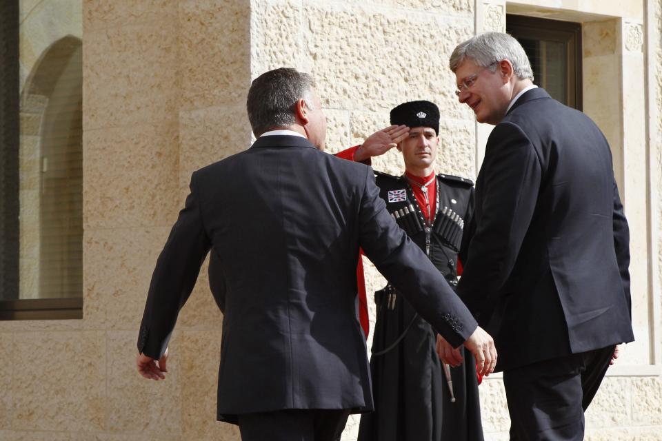 Jordan's King Abdullah welcomes Canada's PM Harper at the Royal Palace in Amman